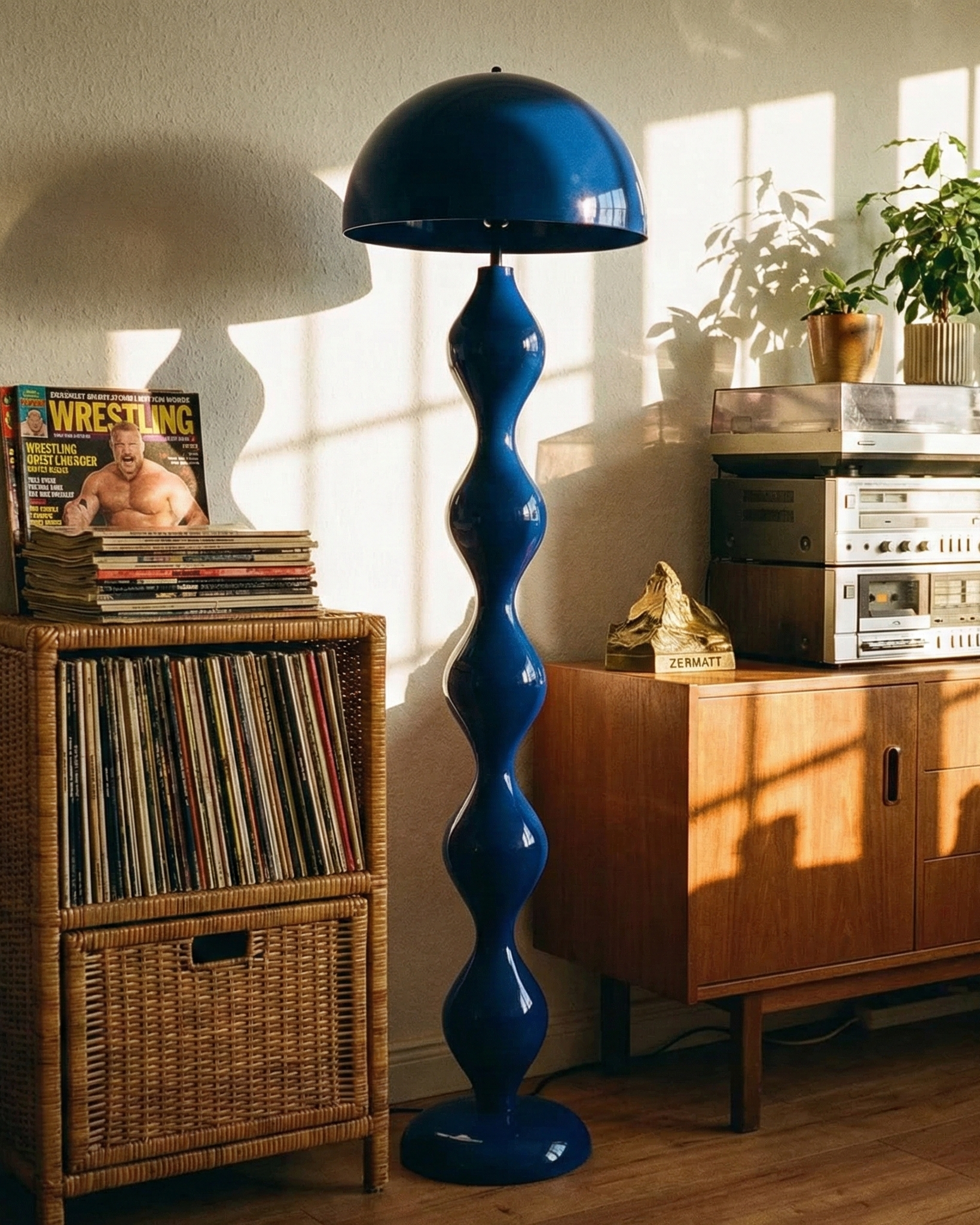 Blue floor lamp in a room with records, magazines, and a vintage stereo system.