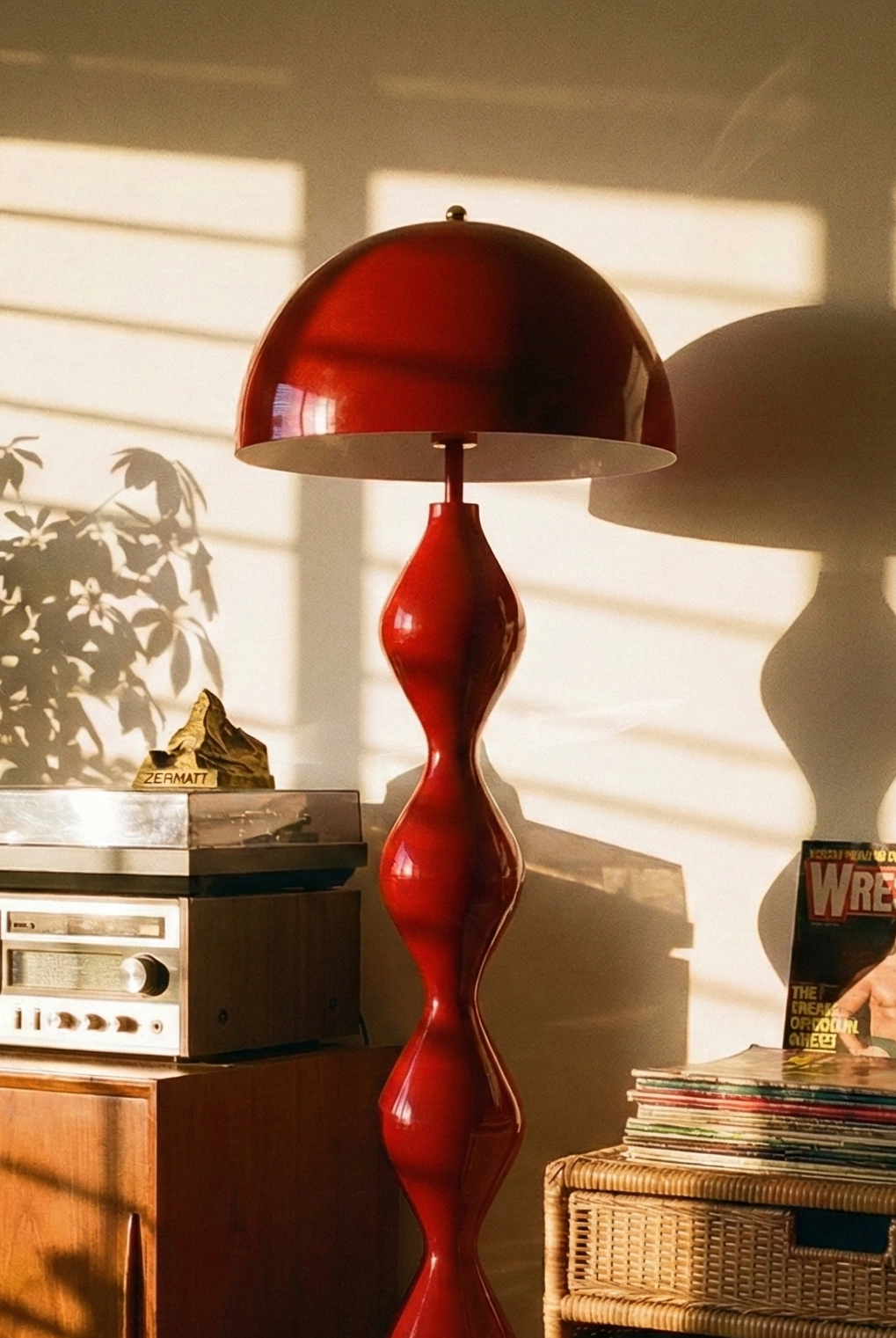 Vintage-style room with red lamp, record player, and wrestling magazines.
