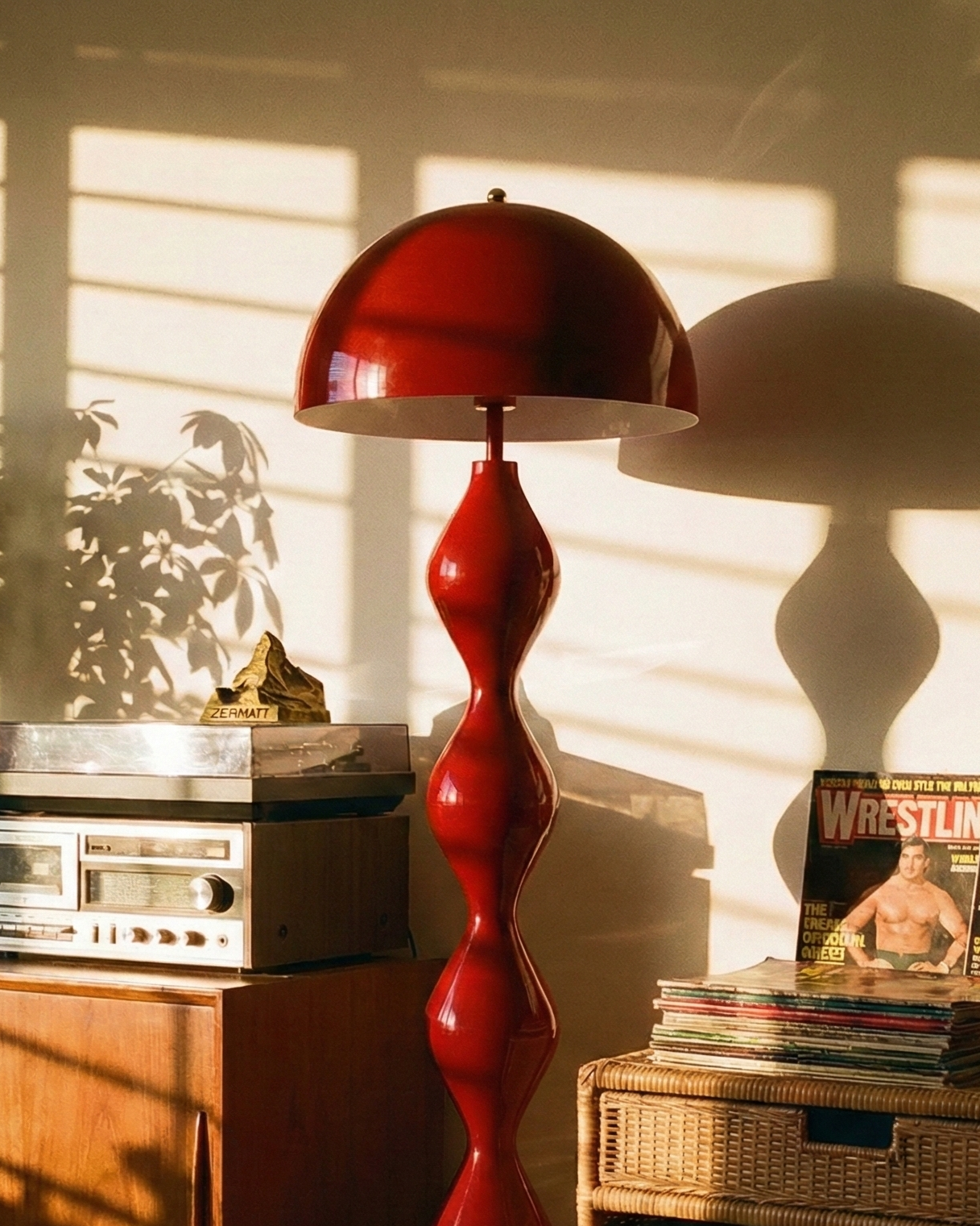 Vintage-style room with red lamp, record player, and wrestling magazines.