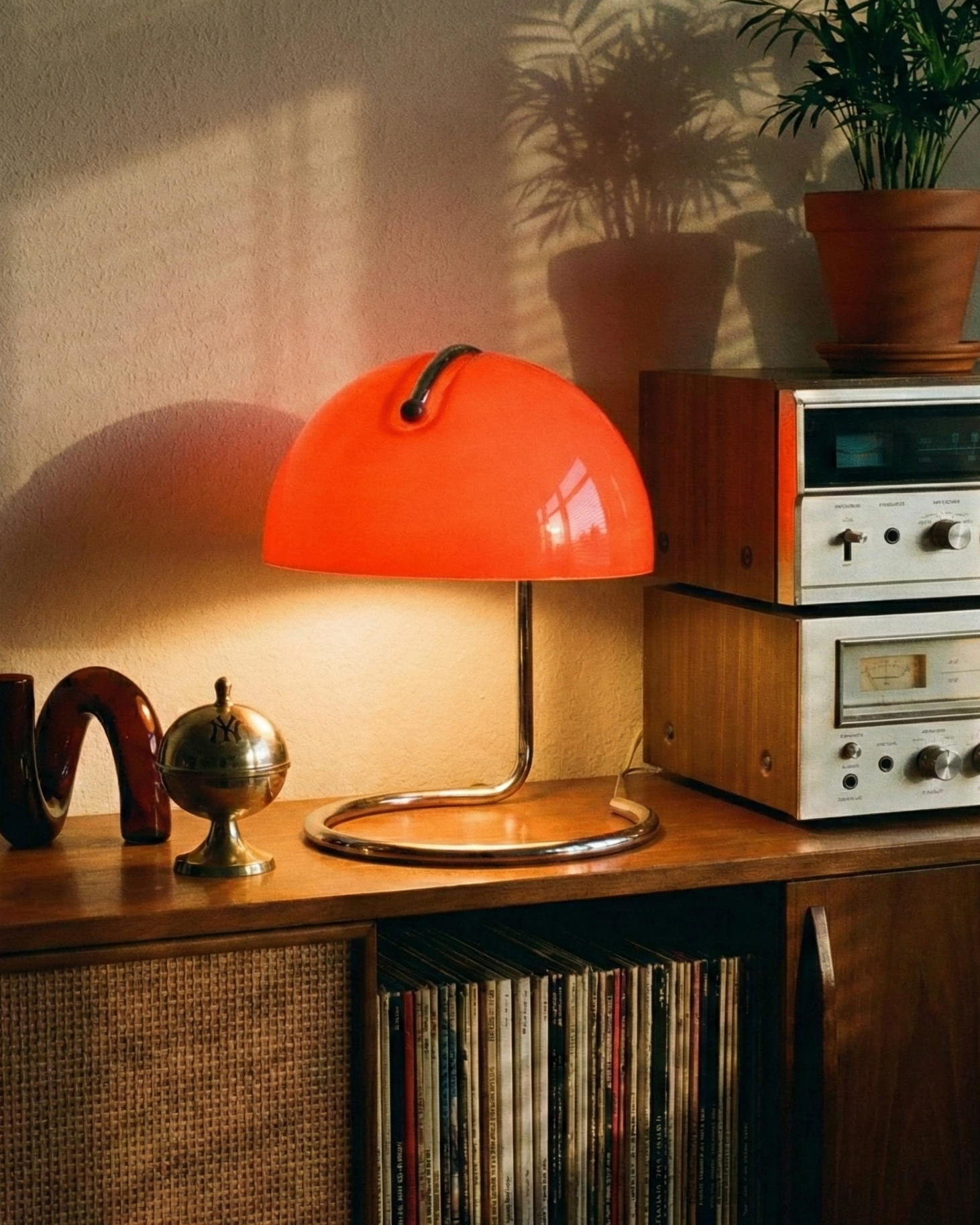 Vintage-style room with orange lamp, vinyl records, and retro equipment.