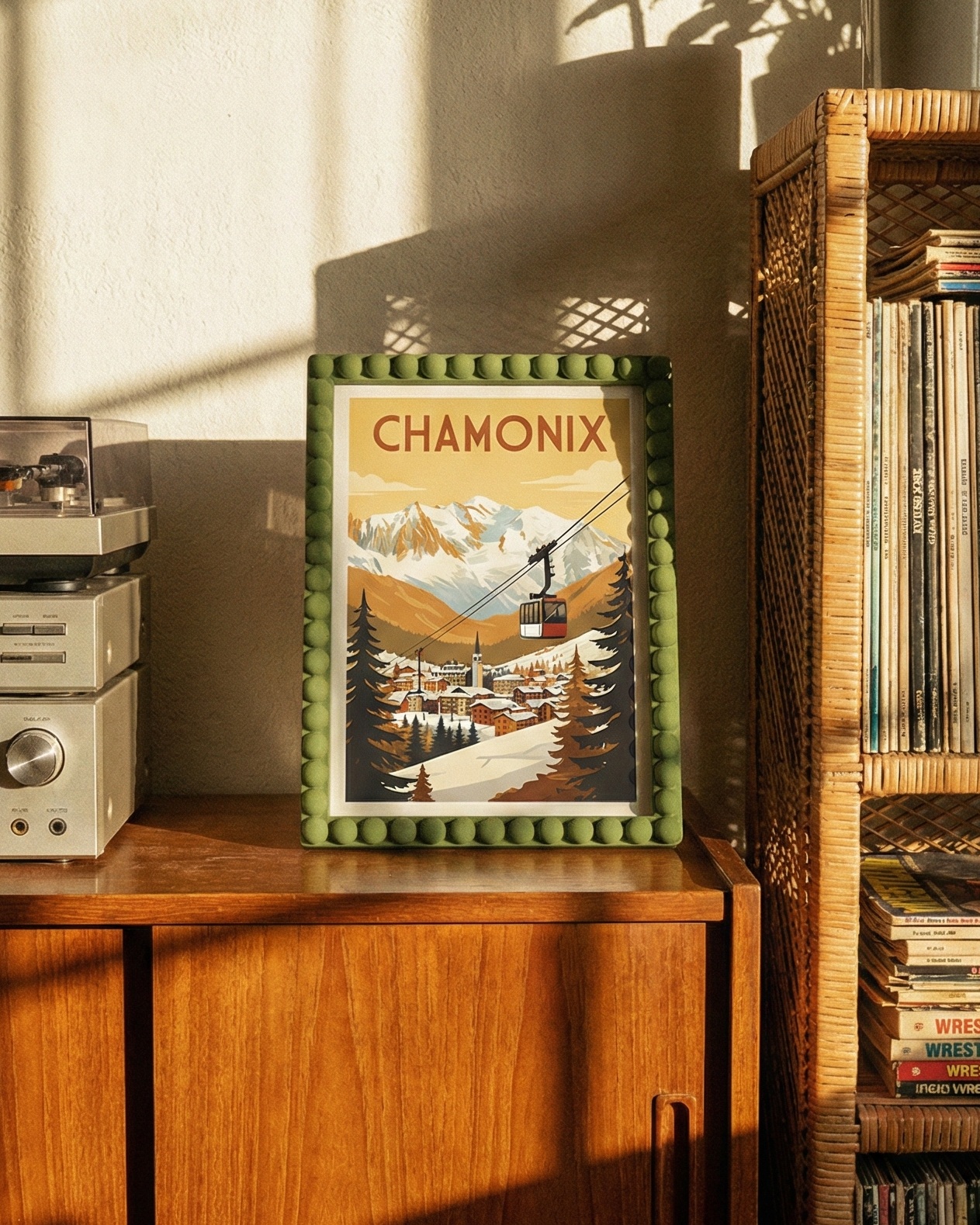 Framed picture of Chamonix on a wooden surface with vinyl records and a record player.