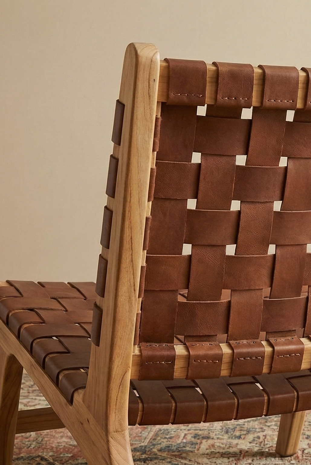 Brown woven chair in a room with a coat rack and jacket.