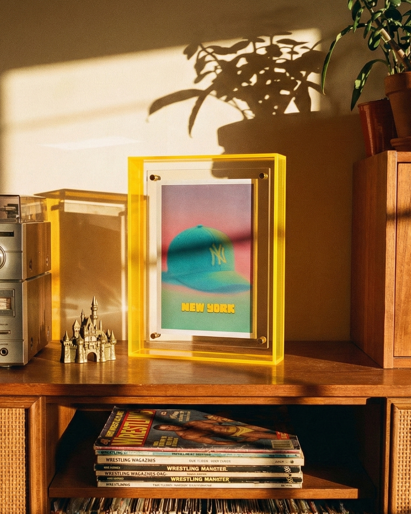 Wooden shelf with records, a framed picture, and a vintage radio in a warm-lit room.