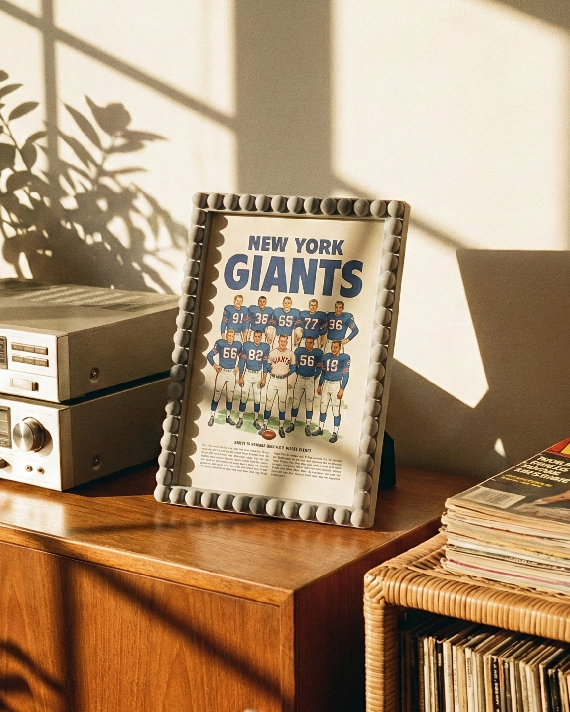 Wooden shelf with vintage stereo equipment, framed New York Giants poster, and vinyl records.