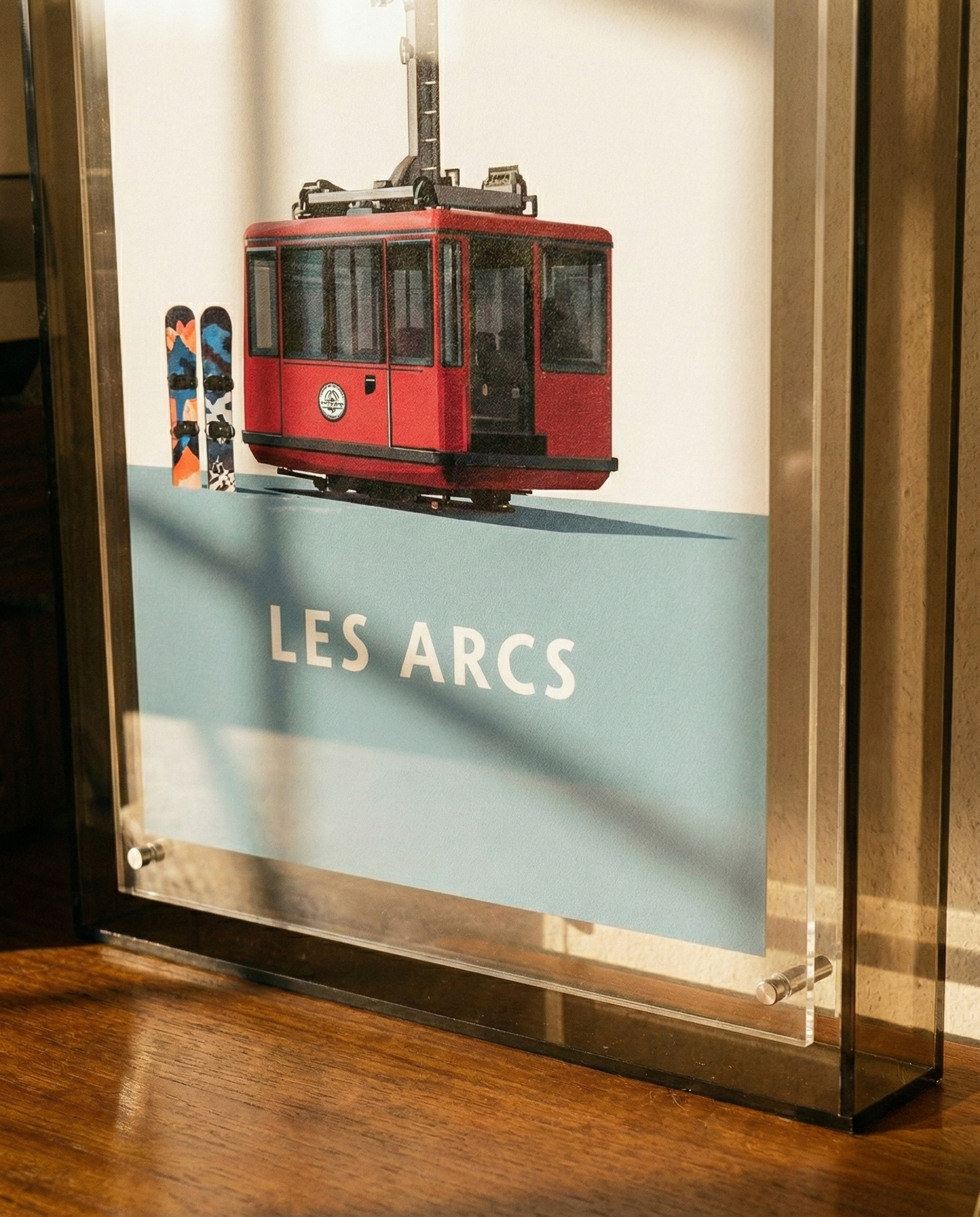 Model of a red tram with 'LES ARCS' branding on a display case.