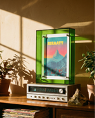 Vintage radio on a wooden shelf with vinyl records and framed artwork in a sunlit room.
