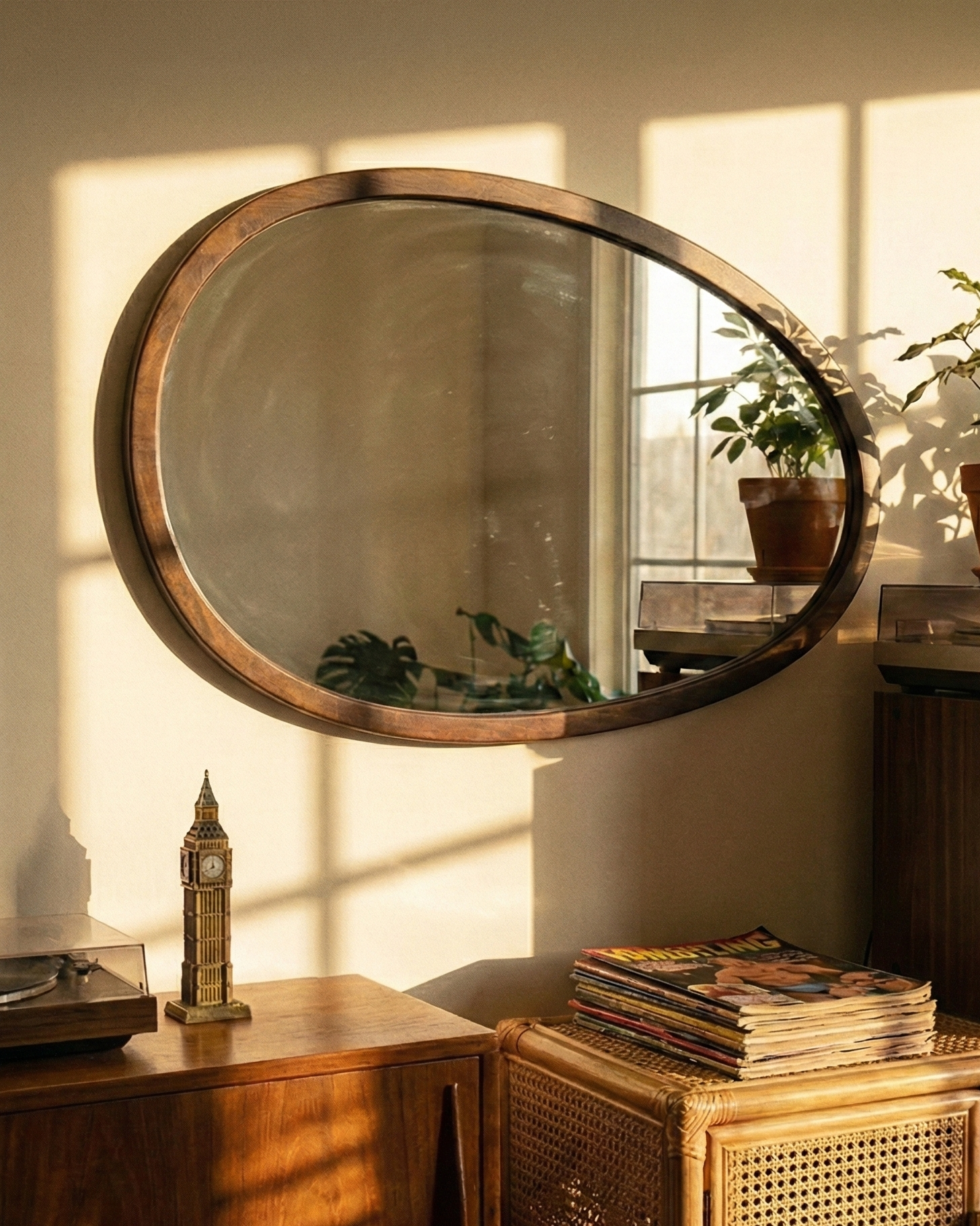 Vintage stereo system with vinyl records, a round mirror, and potted plants in a warm-lit room.